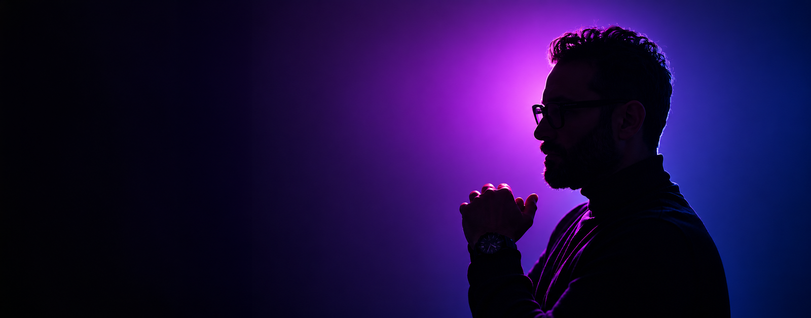 Mohamed Elabbasy in profile, illuminated by blue and purple light