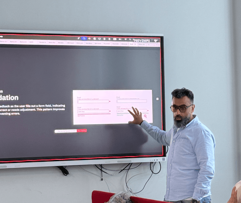 Mohamed teaching a design workshop at a presentation screen