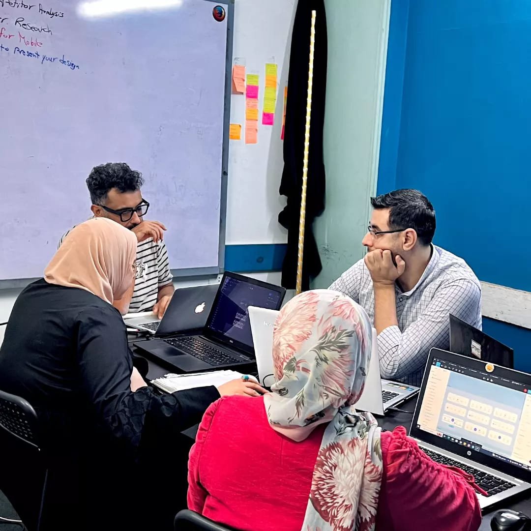 Mohamed mentoring designers during a group session